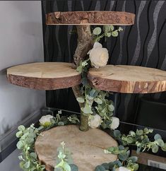 three tiered wooden cake stand with flowers and greenery