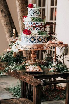 a multi layer cake sitting on top of a wooden table