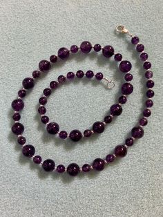 Beautiful deep purple round amethyst beads in 6 & 8mm spaced with tiny sterling silver accents. Finished with a sterling silver trigger clasp. Approximately 19" in length. Classic Amethyst Purple Necklace, Classic Purple Amethyst Necklace, Hand-strung Round Purple Jewelry, Purple Round Hand-strung Jewelry, Hand-strung Purple Round Jewelry, Purple Hand-strung Necklaces, Polished Amethyst Beaded Necklace, Round Amethyst Beaded Necklace With Polished Beads, Purple Amethyst Necklace With 8mm Beads