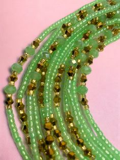 Single Strand Waist Bead, featuring delicate seafoam green glass seed beads accented with luxurious gold crystal glass beads. Why You'll Love It: Subtle Elegance: Seafoam green glass seed beads offer a soft, soothing sparkle that complements any outfit. Luxurious Accents: Gold crystal glass beads add a touch of sophistication and opulence. Perfect Fit: The adjustable single strand design ensures comfort and a secure fit for all body types. Cultural Beauty: This piece blends the rich heritage of Ivorian craftsmanship with modern elegance. Color Significance: Seafoam Green: In Ivorian culture, green symbolizes growth, harmony, and renewal. The seafoam green beads bring a sense of tranquility and balance. Gold: Gold represents wealth, prosperity, and high status. The gold accents provide a lu Adjustable Green Beaded Bracelets With Gold Beads, Green Multi-strand Beaded Jewelry, Green Multi-strand Jewelry With Tiny Beads, Green Adjustable Beaded Bracelets With Oval Beads, Adjustable Green Beads For Festive Occasions, Green Beaded Bracelet With Gold Beads, Bohemian Green Beaded Bracelets With Gold Beads, Festive Green Beaded Bracelets With Colorful Beads, Festive Green Beaded Bracelets