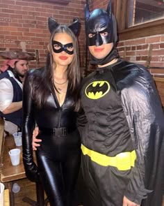 two people dressed up as batman and catwoman