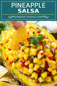 a pineapple salsa is garnished with cilantro and red peppers