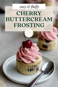 a cupcake sitting on top of a white plate next to a fork and spoon