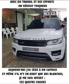 a white car parked on the side of a road next to a building with words written in french