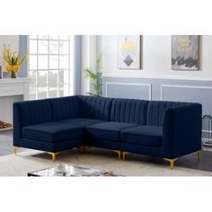 a blue couch sitting in a living room on top of a white carpeted floor