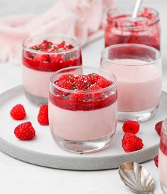 three glasses filled with raspberry pudding on a plate