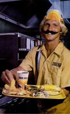 a man with a fake mustache holding a plate of food