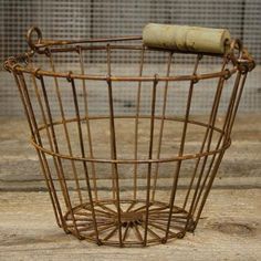 an old rusty wire basket with a roll of paper sticking out of the top and bottom