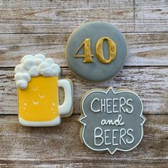 two decorated cookies with the number forty and beer mugs on them, sitting next to each other