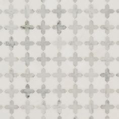 a white and grey tiled wall with cross design on the top, as well as an area for text