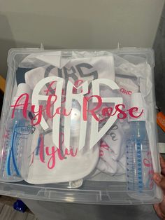 a plastic container filled with lots of baby items in it's lid and the words afif rose on it