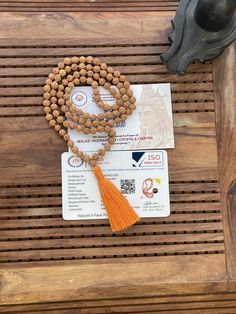 This is a divine Rudraksha beads  mala. This is a five Mukhi Rudraksha beads mala with 108+1 beads with a beautiful orange colour tassel.  These are natural unpolished Rudraksha beads.  Original lab certificates will be sent with the Japa mala.  Every mala will have a unique specimen number  The number 108 is significant for so many reasons. Some believe there are 108 stages on the journey of human soul, while others associate the possibility of enlightenment with taking only 108 breath a day while in deep meditation. Spiritually Rudraksha mala have been used for meditation since centuries. One legend say that once when Lord Shiva opened his eyes after a long period of yogic meditation, he felt sense of extreme fulfilment. It made him shed a tear. This single tear from Shiva eyes grew into Temple Jewelry Mala With Round Beads For Meditation, Chanting Meditation, Shiva Eye, Rudraksha Mala, Rudraksha Beads, Beads Mala, Deep Meditation, Orange Colour, Human Soul