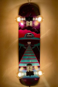 a skateboard is hanging on the wall with light bulbs around it's edges