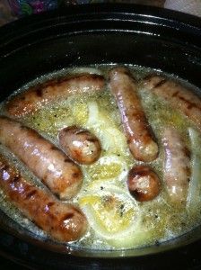 some sausages are cooking in a crock pot