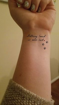 a woman's arm with a tattoo saying nothing loved is ever lost