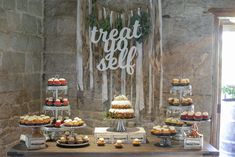 a dessert table filled with cakes and cupcakes