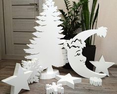 a white christmas tree surrounded by stars and shapes