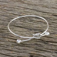 Sterling Silver Wire Bangle Bracelet with Knot Pendant - Tie the Knot | NOVICA Swirly Earrings, Silver Cat Pendant, Wire Bangle Bracelets, Elephant Pendant Necklace, Hand Crafts, Wire Bangles, Wire Wrapped Bracelet, Sterling Silver Bangle, Sterling Silver Drop Earrings