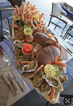 a table topped with lots of different types of seafood