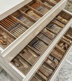 two drawers filled with lots of silverware