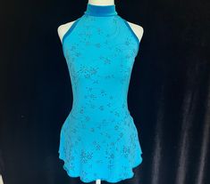 a mannequin wearing a blue dress with floral designs on it's neck