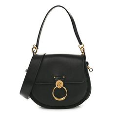 This is an authentic CHLOE Calfskin Suede Large Tess Bag in Black. This bag is crafted of black calfskin leather. The bag features black leather trim, two removable straps with stylized large handle anchors, and a gold loop on the crossover flap. The bag unsnaps to a beigeinterior with a patch pocket. Beige Interior, Anchors, Leather Trim, Tote Handbags, Leather Trims, Crossover, Patch Pocket, Calf Skin, Chloe