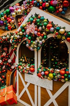 christmas decorations are on display in front of a building