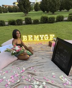 a woman sitting on top of a bed next to a sign that says, be my bride