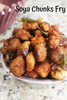 a white plate topped with fried food on top of a table