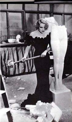 an old black and white photo of a woman cleaning the floor with a mop