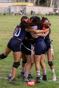 a group of girls huddle together on the field