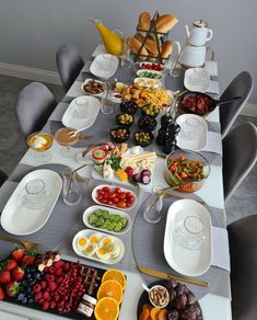 a long table filled with plates and bowls of food