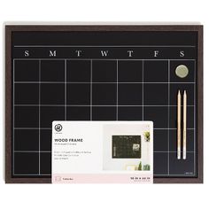 a wooden frame with a calendar and pencils