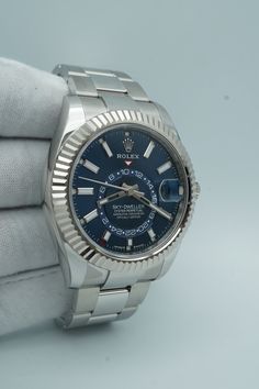 Introducing the Rolex 336934 Sky-Dweller, a luxurious timepiece crafted with 18k white gold and a stunning blue dial. The fluted bezel adds a touch of sophistication, while the Oyster bracelet provides both style and comfort. Complete with a 2024 set, this is a must-have for any watch enthusiast. Condition: Unworn Accessories: Original Box & Papers Warranty Dated: 2024 Details Reference Number: 333934 Model: Sky-Dweller 336934-0005 Movement: Automatic Bezel Material: 18K White Gold Dial: Blue Ca Luxury Blue Watch Accessories With Date Indicator, Luxury Blue Watches With Diamond Hour Markers, Luxury Blue Watch With Diamond Hour Markers, Luxury Blue Watch With Polished Finish, Rolex Skydweller Blue, Rolex Yachtmaster Blue, Rolex Day Date Platinum Ice Blue, Luxury Blue Chronometer Watch, Rolex Usa