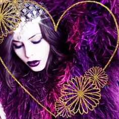 a woman in a purple fur coat with a heart shaped decoration on her head and chest