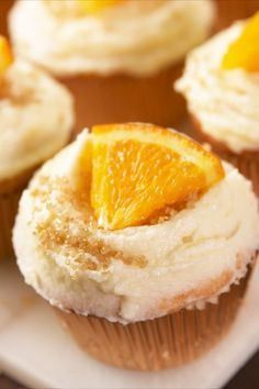 cupcakes with frosting and orange slices on top