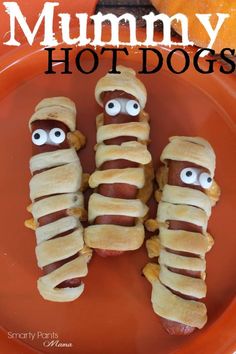 three hot dogs wrapped in banana peels with googly eyes on them and the words, mommy hot dogs