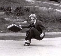 a man riding a skateboard down a street