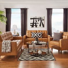 a living room filled with lots of furniture next to two windows and a painting on the wall