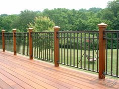 a wooden deck with wrought iron railings