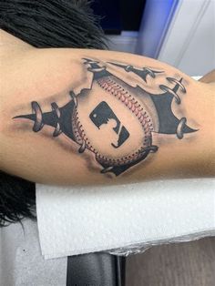 a man with a baseball tattoo on his arm