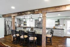 an open kitchen and dining room with wood floors