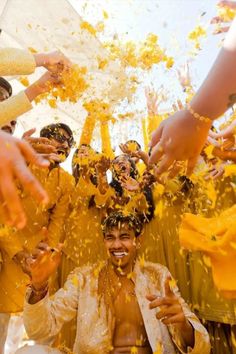 a group of people throwing confetti on each other