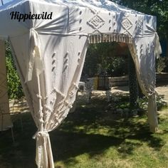 a white tent sitting on top of a lush green field