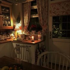 a kitchen filled with lots of furniture and decor next to a window covered in christmas lights