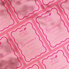 pink and white wedding stationery with the word kiss me in cursive