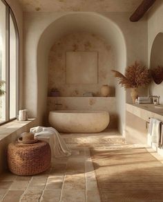 a bath room with a tub a sink and a large window next to each other