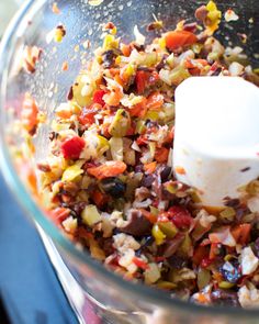 a food processor filled with chopped vegetables and diced into small cubes on the side