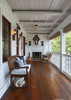 a porch with wooden floors and white walls