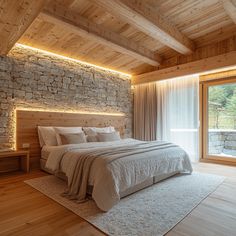 a bedroom with stone walls and flooring is lit by recessed lights on either side of the bed